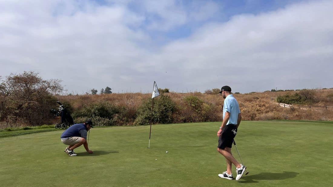Golfer putting on the green at a tournament